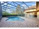 An in-ground swimming pool with a screened enclosure at 11733 Delwick Dr, Windermere, FL 34786