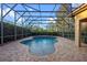 An in-ground swimming pool with a large screened enclosure at 11733 Delwick Dr, Windermere, FL 34786