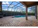 Backyard swimming pool under an screened enclosure at 11733 Delwick Dr, Windermere, FL 34786