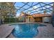 A beautiful in-ground swimming pool with a large screened enclosure at 11733 Delwick Dr, Windermere, FL 34786