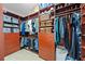 Organized walk-in closet with built-in shelving, drawers, and ample hanging space for clothes and accessories at 11733 Delwick Dr, Windermere, FL 34786