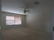 Expansive bedroom featuring neutral walls, carpeted flooring, a window with blinds, and a ceiling fan at 1230 Elegance Ct, Orlando, FL 32828