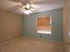 Comfortable bedroom featuring carpet, a window with blinds, and a ceiling fan, offering a relaxing retreat at 1230 Elegance Ct, Orlando, FL 32828