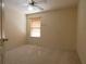 Neutral bedroom with carpet, a window with blinds, and a ceiling fan, creating a cozy and functional space at 1230 Elegance Ct, Orlando, FL 32828