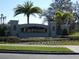 Eastwood community entrance with stone sign, palm trees, landscaping, and decorative lighting at 1230 Elegance Ct, Orlando, FL 32828