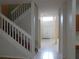 Welcoming home entryway featuring a staircase and tiled flooring at 1230 Elegance Ct, Orlando, FL 32828