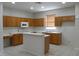 Functional kitchen with wood cabinets, white appliances, a breakfast bar, and ample counter space at 1230 Elegance Ct, Orlando, FL 32828