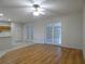 Bright living room featuring hardwood flooring, French doors, and a neutral color scheme at 1230 Elegance Ct, Orlando, FL 32828