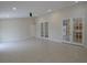 Bright and open living space with tiled floors and natural light from french doors at 1230 Elegance Ct, Orlando, FL 32828