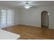 Spacious living room featuring wood floors, arched doorways, and bright neutral paint at 1230 Elegance Ct, Orlando, FL 32828