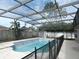 Enclosed pool with clear blue water, complimented by an adjacent storage shed and concrete patio at 1230 Elegance Ct, Orlando, FL 32828