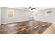 Living room with many windows and dark, wood-look flooring at 1317 Independence Ln, Mount Dora, FL 32757