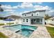 Exterior rear of home features a pool, jacuzzi, and white fencing at 1317 Independence Ln, Mount Dora, FL 32757