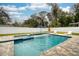 Backyard pool features a connected jacuzzi, an umbrella, and white fencing at 1317 Independence Ln, Mount Dora, FL 32757