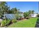 Fenced backyard with a green lawn and mature landscaping at 1714 Leatherback Ln, St Cloud, FL 34771