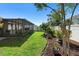 Manicured backyard with green lawn and screened-in patio at 1714 Leatherback Ln, St Cloud, FL 34771