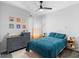 Bright bedroom featuring a ceiling fan, light gray walls, and wood-look vinyl floors at 1714 Leatherback Ln, St Cloud, FL 34771