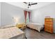 Spare bedroom featuring two twin beds and wood floors, a simple and functional space at 1714 Leatherback Ln, St Cloud, FL 34771