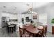 Bright open kitchen and dining area featuring modern appliances and stylish lighting at 1714 Leatherback Ln, St Cloud, FL 34771