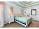 Main bedroom boasting tray ceiling, wood floors, and comfortable, well-lit space at 1714 Leatherback Ln, St Cloud, FL 34771