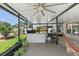 Lush backyard view from the screened porch featuring an outdoor kitchen and a hammock at 1714 Leatherback Ln, St Cloud, FL 34771