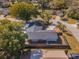 Aerial view of the home with a fenced yard and proximity to a tree-lined street at 172 Post And Rail Rd, Longwood, FL 32750