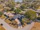 An aerial shot displays a home with mature trees, landscaping, and a circular driveway at 172 Post And Rail Rd, Longwood, FL 32750