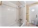 Bathroom with a tub-shower combo featuring white tile and functional shower head at 172 Post And Rail Rd, Longwood, FL 32750