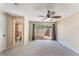 Bright bedroom featuring neutral carpet, ceiling fan, and sliding glass doors to the backyard at 172 Post And Rail Rd, Longwood, FL 32750