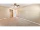 Carpeted bedroom with a ceiling fan, closet, and a doorway to another room at 172 Post And Rail Rd, Longwood, FL 32750