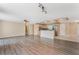 Open-concept living room showcasing wood floors, natural light, and a functional kitchen island at 172 Post And Rail Rd, Longwood, FL 32750