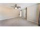 Spacious main bedroom with a ceiling fan, an ensuite bathroom, and neutral-colored carpet and walls at 172 Post And Rail Rd, Longwood, FL 32750