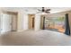 Main bedroom featuring a ceiling fan, ensuite bathroom, and backyard access via sliding glass doors at 172 Post And Rail Rd, Longwood, FL 32750