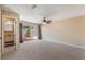 Main bedroom with ensuite bathroom, sliding glass doors, and a ceiling fan at 172 Post And Rail Rd, Longwood, FL 32750