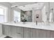 Bright bathroom featuring double sinks, modern vanity, large mirror, and walk-in shower at 2015 Summerfield Rd, Winter Park, FL 32792