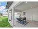 Inviting covered patio featuring a dining table and chairs, with a glimpse of the refreshing pool area at 2015 Summerfield Rd, Winter Park, FL 32792