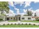 Landscaped modern home with a stone driveway and striking architectural details at 2015 Summerfield Rd, Winter Park, FL 32792