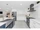 Modern kitchen with white cabinets, stainless steel appliances, and stone countertops at 2015 Summerfield Rd, Winter Park, FL 32792