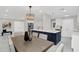 Open concept kitchen and dining area features a modern chandelier and blue kitchen island at 2015 Summerfield Rd, Winter Park, FL 32792