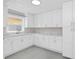 Bright kitchen featuring white cabinets, marble countertops, modern appliances, and ample counter space at 2015 Summerfield Rd, Winter Park, FL 32792
