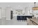 Modern kitchen featuring white cabinetry, dark island, stainless steel appliances, and pendant lighting at 2015 Summerfield Rd, Winter Park, FL 32792