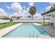 Inviting pool with a travertine surround and a backdrop of lush landscaping and blue skies at 2015 Summerfield Rd, Winter Park, FL 32792