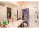 This is a bathroom with a shower and dark colored vanity at 212 Fig Ct, Poinciana, FL 34759