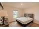 This bedroom has a large window, wood headboard and neutral colors at 212 Fig Ct, Poinciana, FL 34759