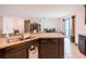 Kitchen island with granite countertops and dark cabinetry overlooking the living area at 212 Fig Ct, Poinciana, FL 34759