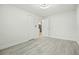 Cozy bedroom with light wood flooring, a closet, and a doorway leading to the kitchen at 230 Hennis Rd, Winter Garden, FL 34787