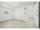 Spacious bedroom with wood-look floors, closet, bright window, and white walls at 230 Hennis Rd, Winter Garden, FL 34787