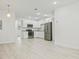 Modern kitchen featuring stainless steel appliances, white cabinets, and light wood flooring at 230 Hennis Rd, Winter Garden, FL 34787