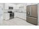 Well-lit kitchen featuring stainless steel appliances and white cabinets with granite countertops at 230 Hennis Rd, Winter Garden, FL 34787