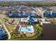 Beautiful aerial shot of a community pool, modern apartment homes, and a tranquil lake on a sunny day at 2331 Celebration Blvd, Celebration, FL 34747